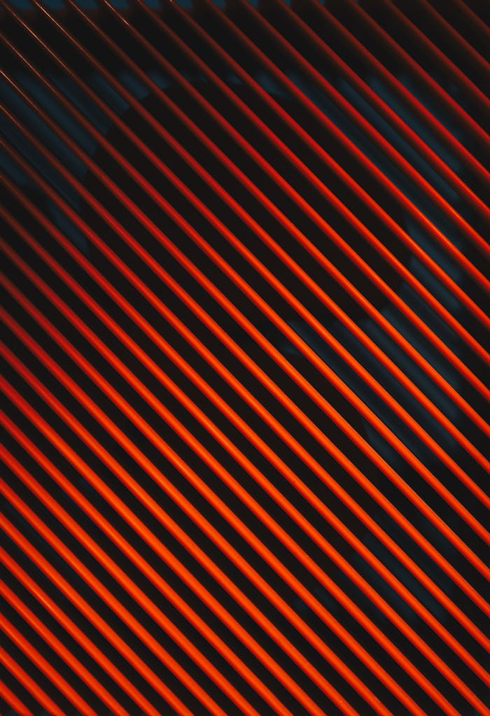 Dynamic abstract pattern of diagonal orange stripes against a dark background, providing a striking visual impact.